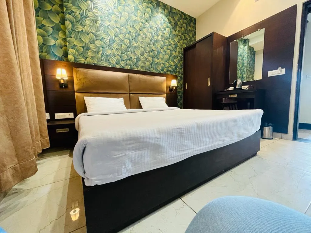 Deluxe Room category at Grand Regency Pathankot with nature-inspired leaf wallpaper